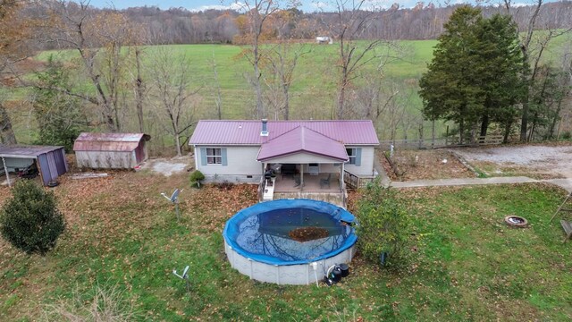 view of home's exterior with a lawn and a covered pool