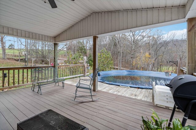 wooden terrace with ceiling fan, a mountain view, and area for grilling