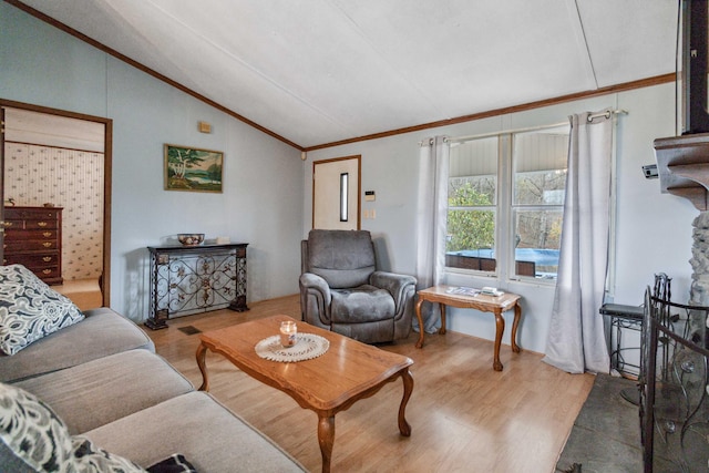 living area with vaulted ceiling, light wood finished floors, and ornamental molding