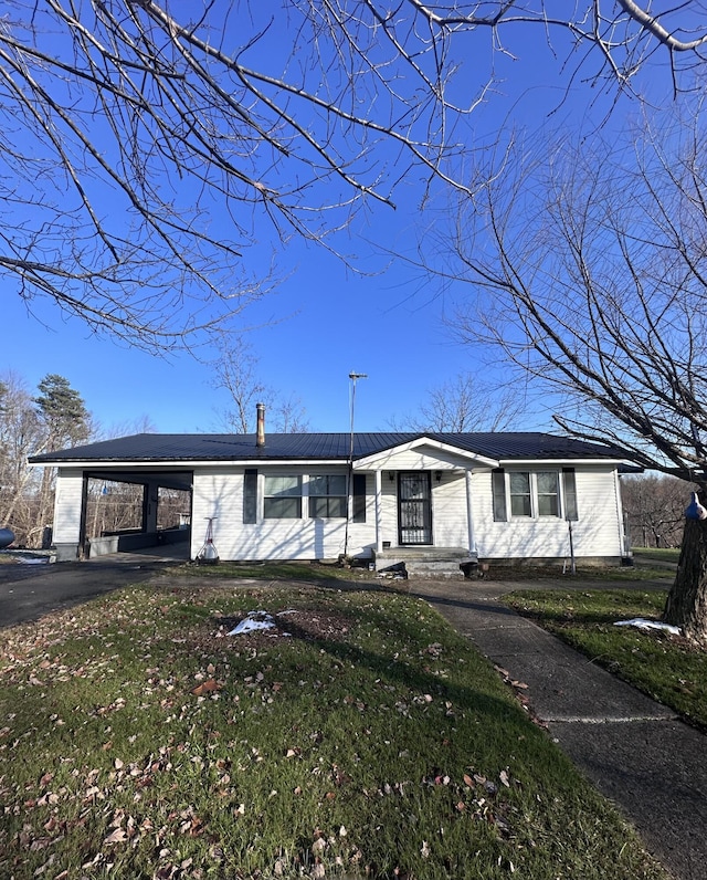 view of front of home with a front yard and a carport