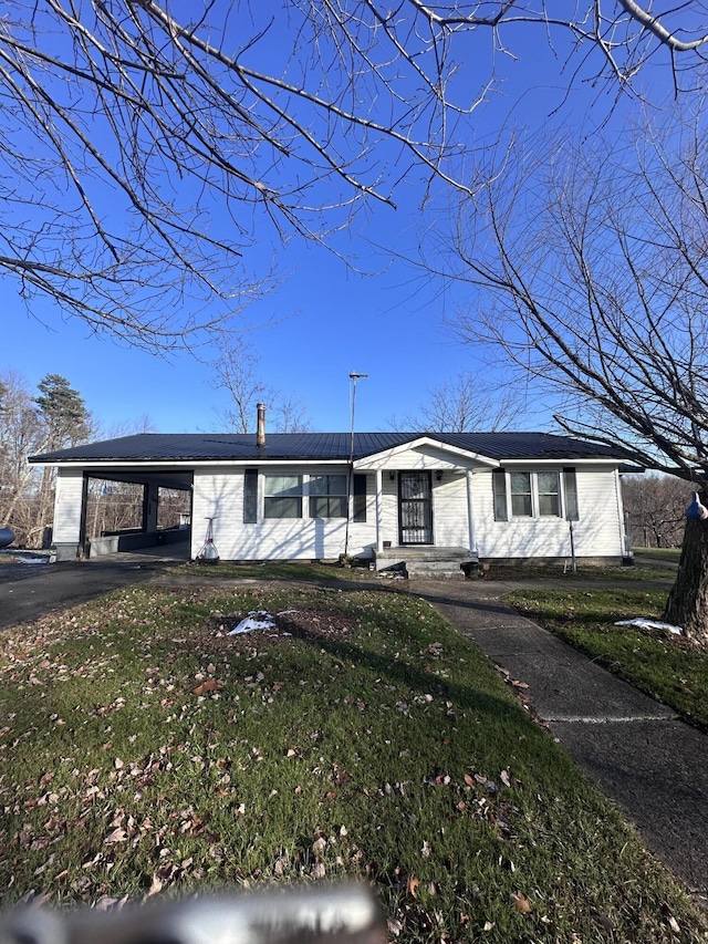 ranch-style home featuring a carport and a front yard