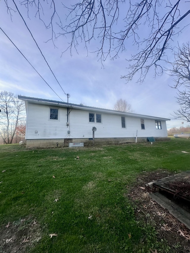 back of house with a lawn