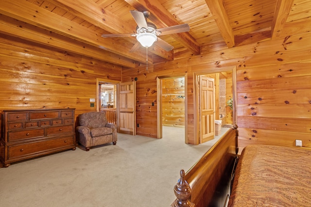 bedroom featuring carpet flooring, beam ceiling, ceiling fan, and wooden walls