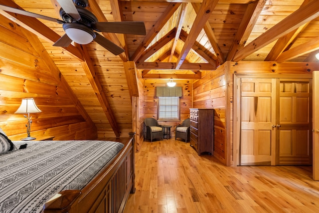 unfurnished bedroom featuring vaulted ceiling with beams, light hardwood / wood-style floors, wood ceiling, and wooden walls