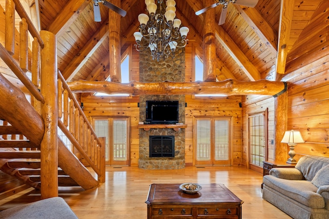 living room with plenty of natural light, beam ceiling, and light hardwood / wood-style flooring