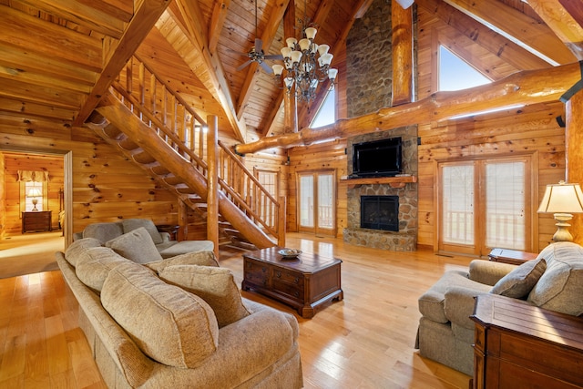 living room featuring beamed ceiling, ceiling fan, light hardwood / wood-style floors, and high vaulted ceiling