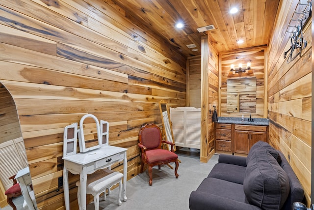 unfurnished room with light carpet, wooden ceiling, and wooden walls