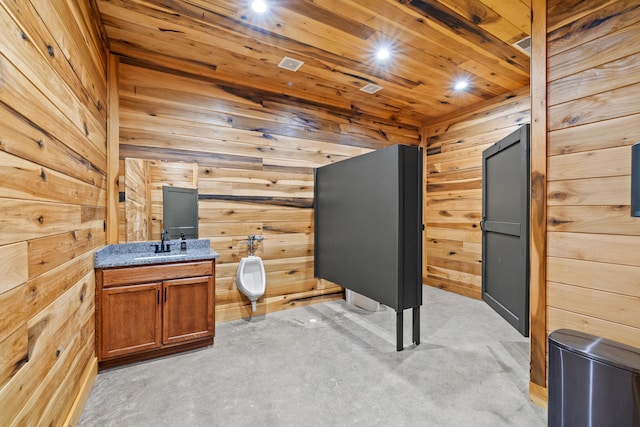 unfurnished office with wood walls, wooden ceiling, and sink