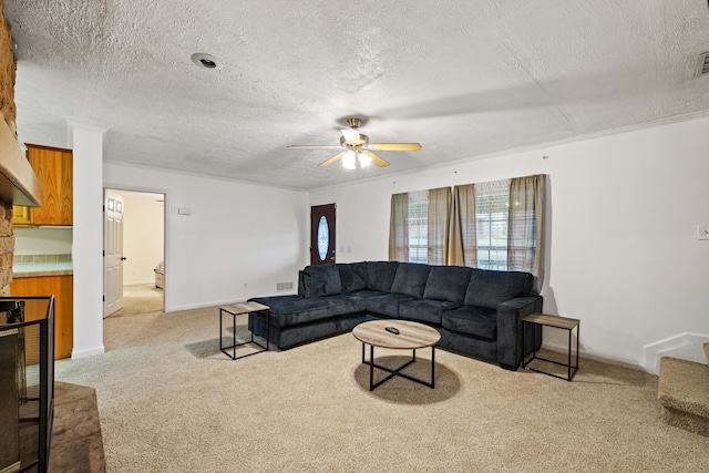 carpeted living room featuring ceiling fan and a textured ceiling