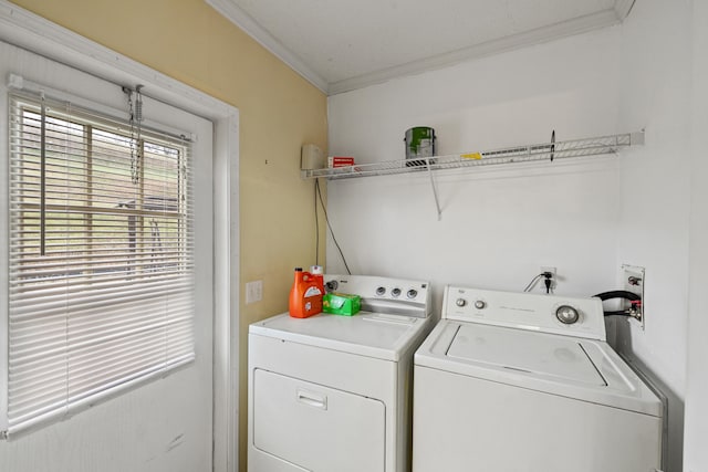 clothes washing area featuring separate washer and dryer and ornamental molding