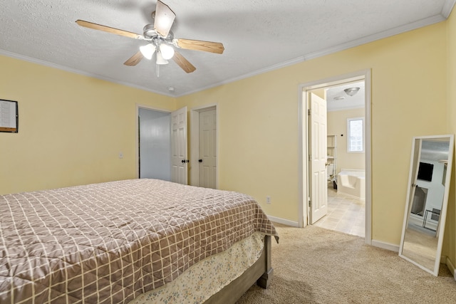 bedroom with ensuite bath, ceiling fan, light colored carpet, a textured ceiling, and ornamental molding