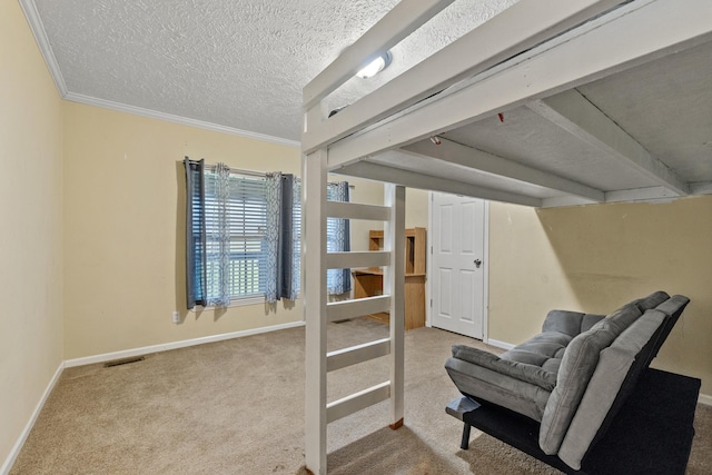 interior space featuring light colored carpet, a textured ceiling, and ornamental molding