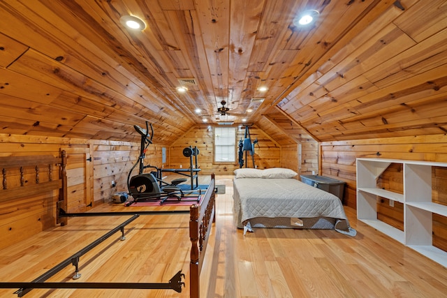 bedroom with wooden walls, light hardwood / wood-style floors, lofted ceiling, and wood ceiling