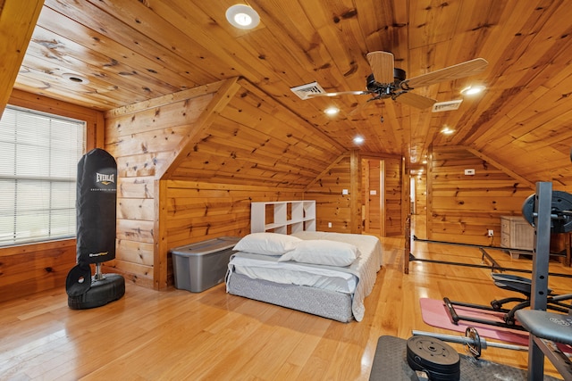 bedroom featuring wooden walls, light hardwood / wood-style flooring, lofted ceiling, and wood ceiling