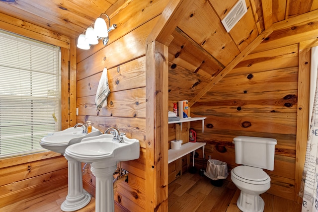 bathroom with wooden ceiling, wooden walls, wood-type flooring, and toilet