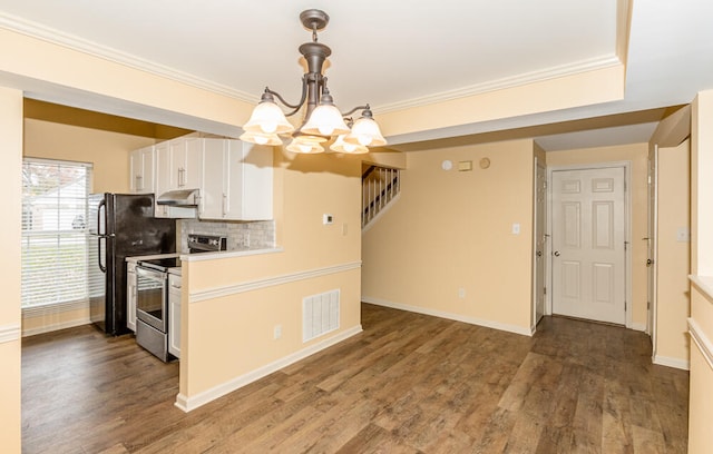 kitchen with backsplash, white cabinets, dark wood-type flooring, and appliances with stainless steel finishes