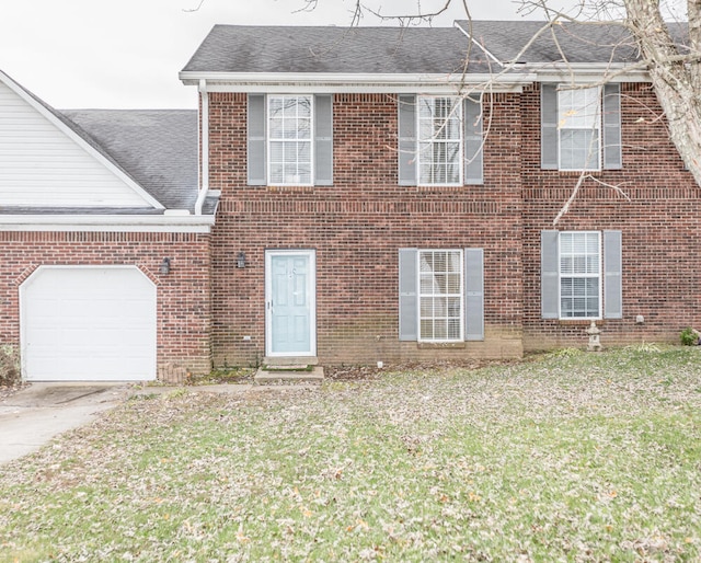 view of front of house with a garage and a front lawn