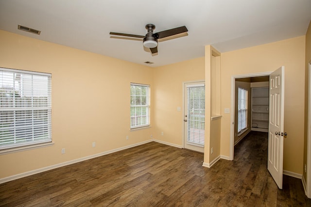 spare room with dark hardwood / wood-style flooring and ceiling fan