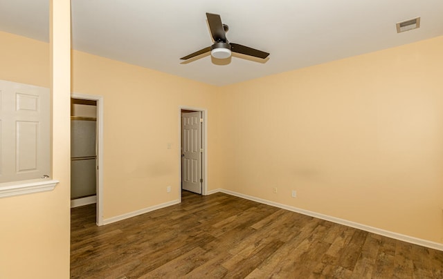 unfurnished bedroom featuring ceiling fan and dark wood-type flooring