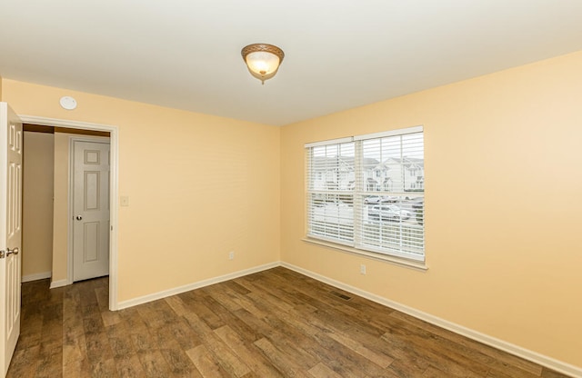 unfurnished room featuring dark hardwood / wood-style floors