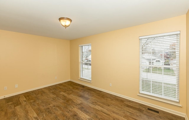 empty room featuring dark hardwood / wood-style flooring