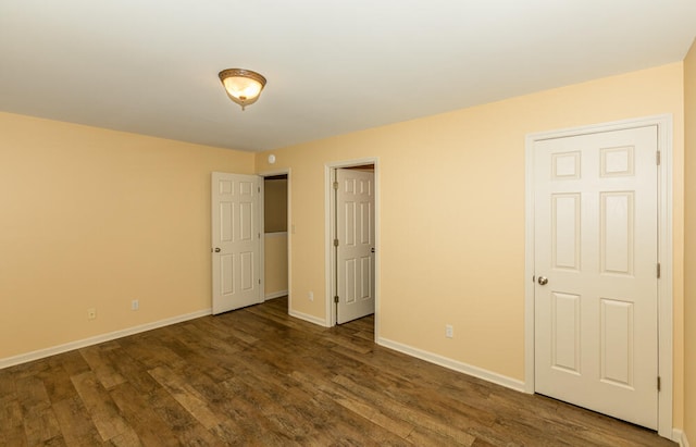 unfurnished bedroom featuring dark hardwood / wood-style floors