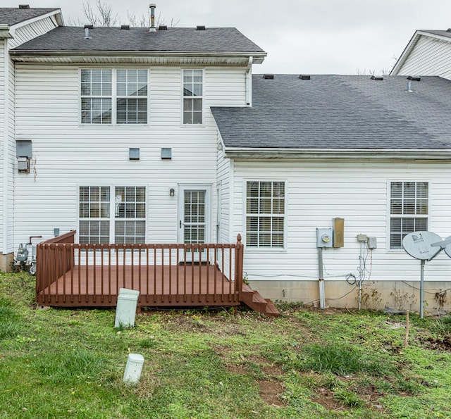 rear view of house featuring a yard and a wooden deck