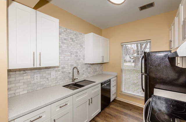 kitchen featuring sink, white cabinets, dark wood-type flooring, and black dishwasher