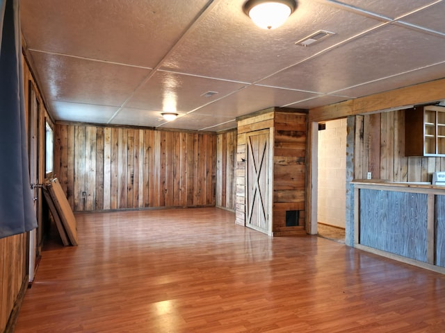 interior space featuring wood walls and hardwood / wood-style flooring