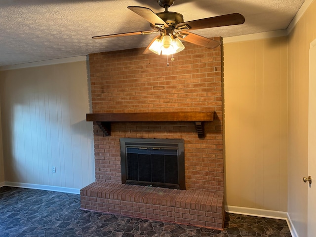 interior details with ceiling fan, wood walls, a textured ceiling, and a brick fireplace