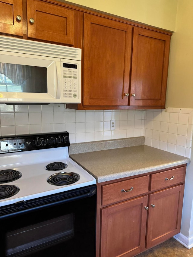 kitchen featuring white appliances and tasteful backsplash