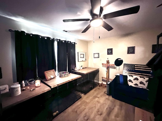 bathroom with ceiling fan and hardwood / wood-style flooring