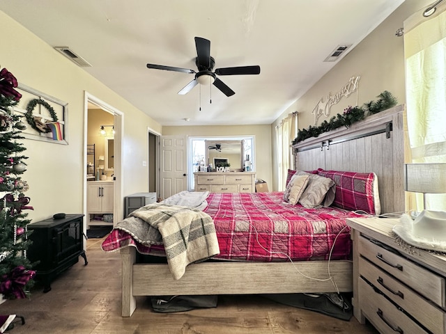 bedroom featuring ensuite bath, ceiling fan, and wood-type flooring