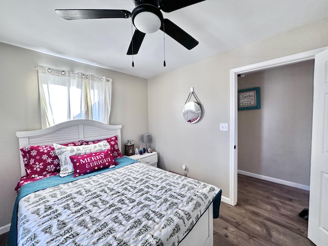 bedroom with dark hardwood / wood-style flooring and ceiling fan