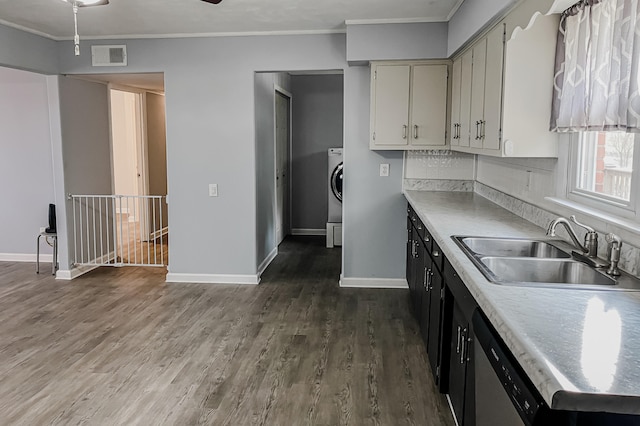 kitchen with stainless steel dishwasher, dark hardwood / wood-style floors, crown molding, and sink