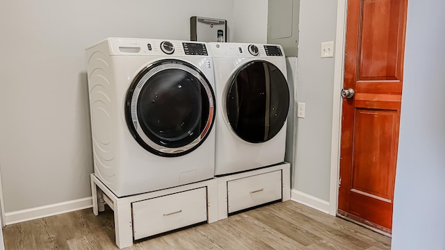 laundry room with light hardwood / wood-style floors and washing machine and dryer