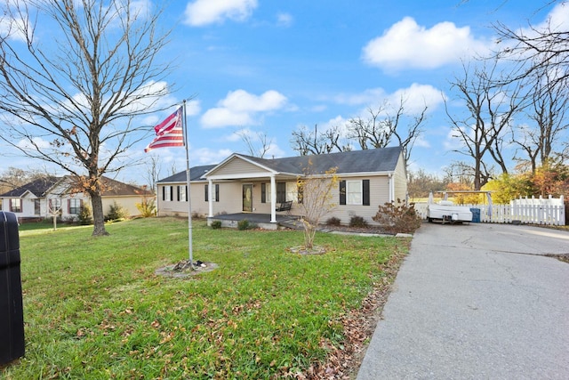 single story home with a porch and a front lawn