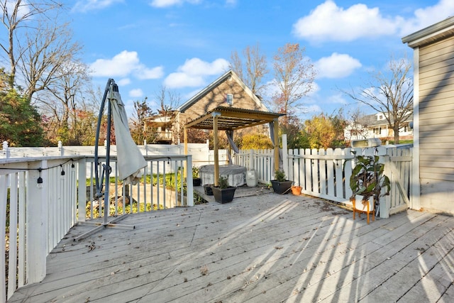 wooden terrace featuring a hot tub