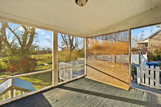 sunroom / solarium featuring lofted ceiling