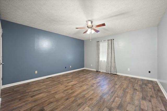 empty room with a textured ceiling, dark hardwood / wood-style flooring, and ceiling fan