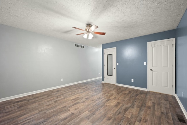 unfurnished room with ceiling fan, dark hardwood / wood-style flooring, and a textured ceiling