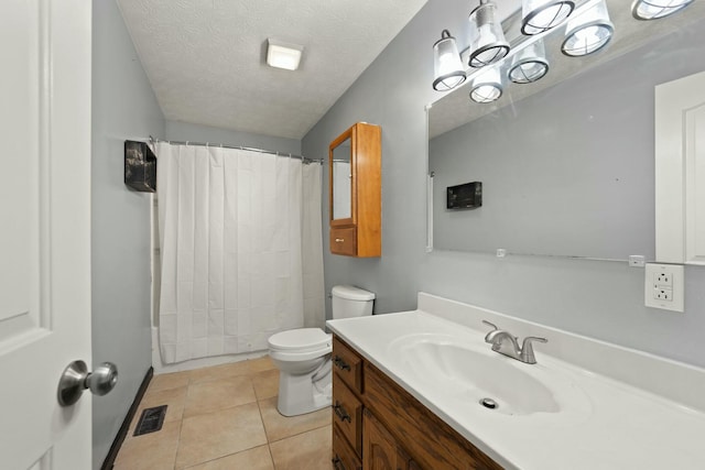 bathroom featuring vanity, tile patterned floors, a textured ceiling, and toilet