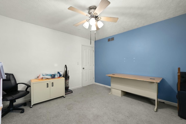 carpeted office with ceiling fan and a textured ceiling