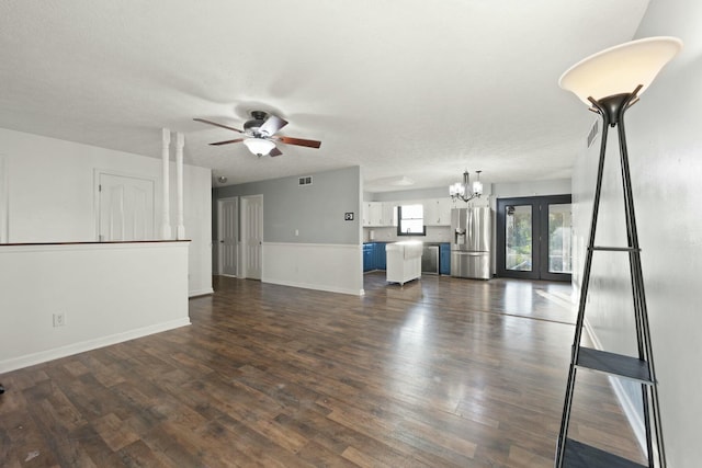 unfurnished living room with a textured ceiling, french doors, dark hardwood / wood-style floors, and ceiling fan with notable chandelier