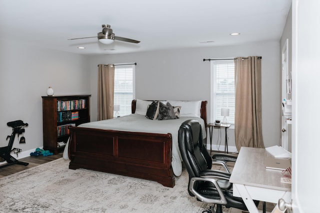 bedroom with light hardwood / wood-style flooring, multiple windows, and ceiling fan