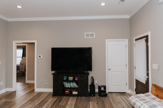 living room featuring wood-type flooring and ornamental molding