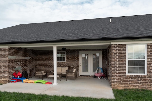 rear view of property featuring outdoor lounge area, ceiling fan, and a patio area