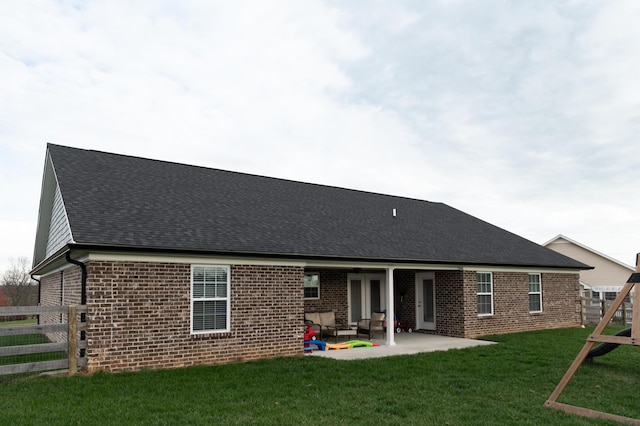 rear view of house with a yard and a patio