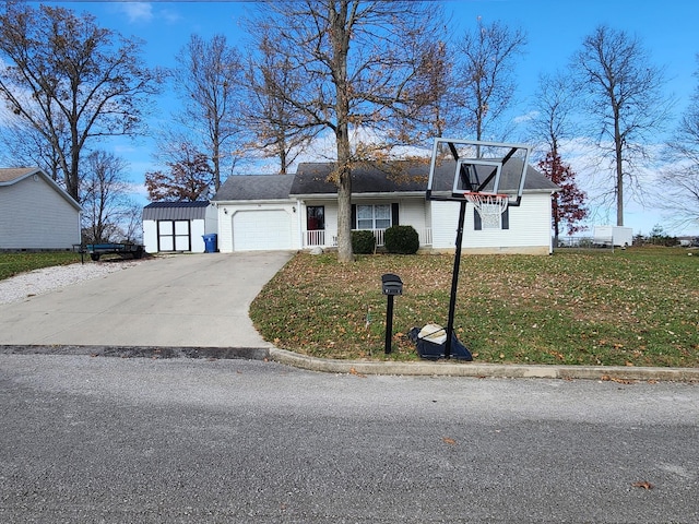 view of front of property featuring a garage, a front yard, and a storage shed