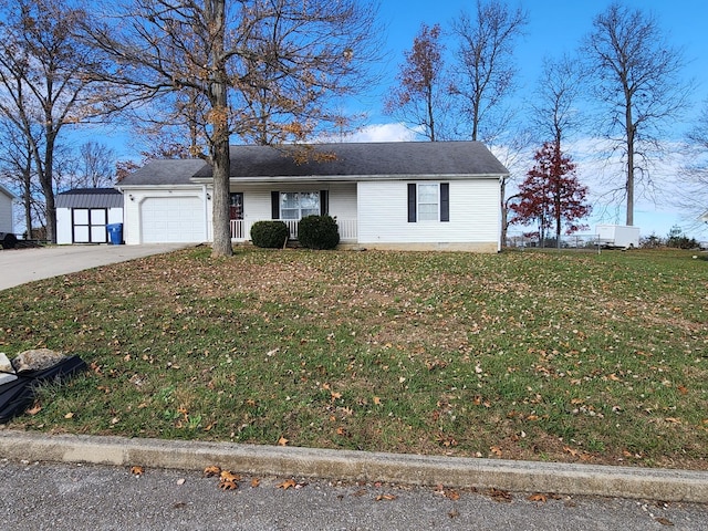 view of front of house featuring a front yard, a garage, and covered porch